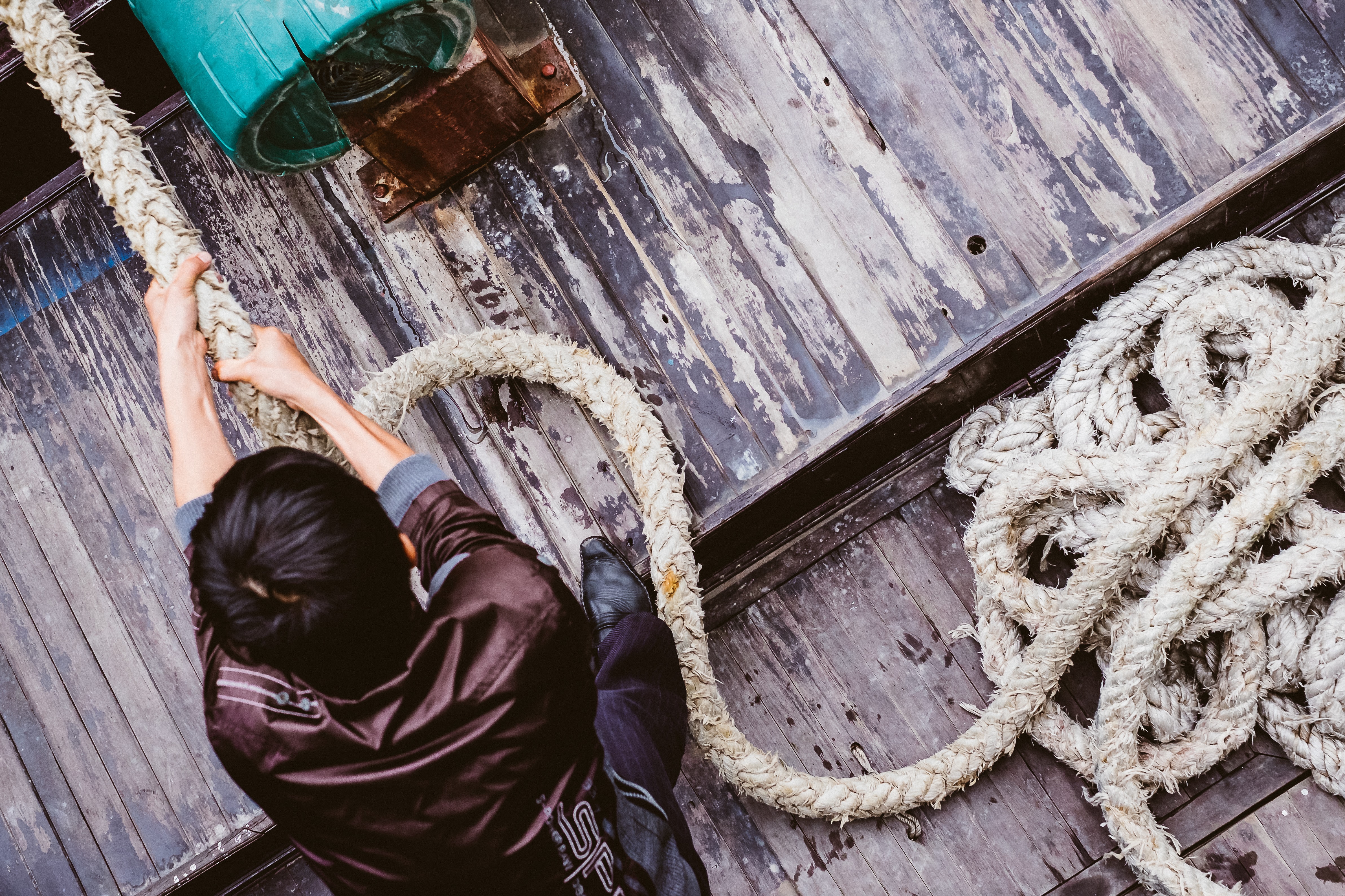 An image of a pair of hands pulling on a rope